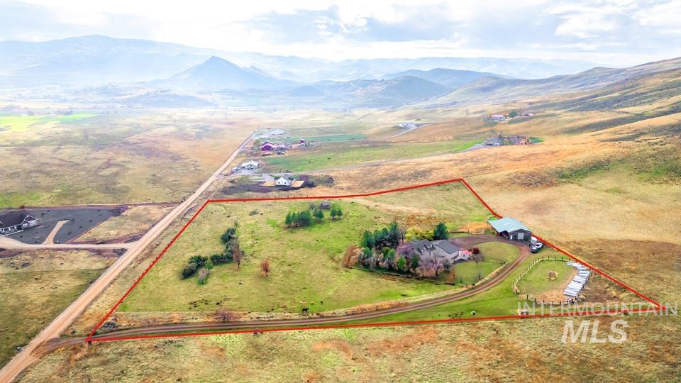 7025 Bluebird Lane Sweet, ID 83670 - Photo 42 of 46 Aerial view of sparsely populated area featuring a mountainous background and property boundaries highlighted