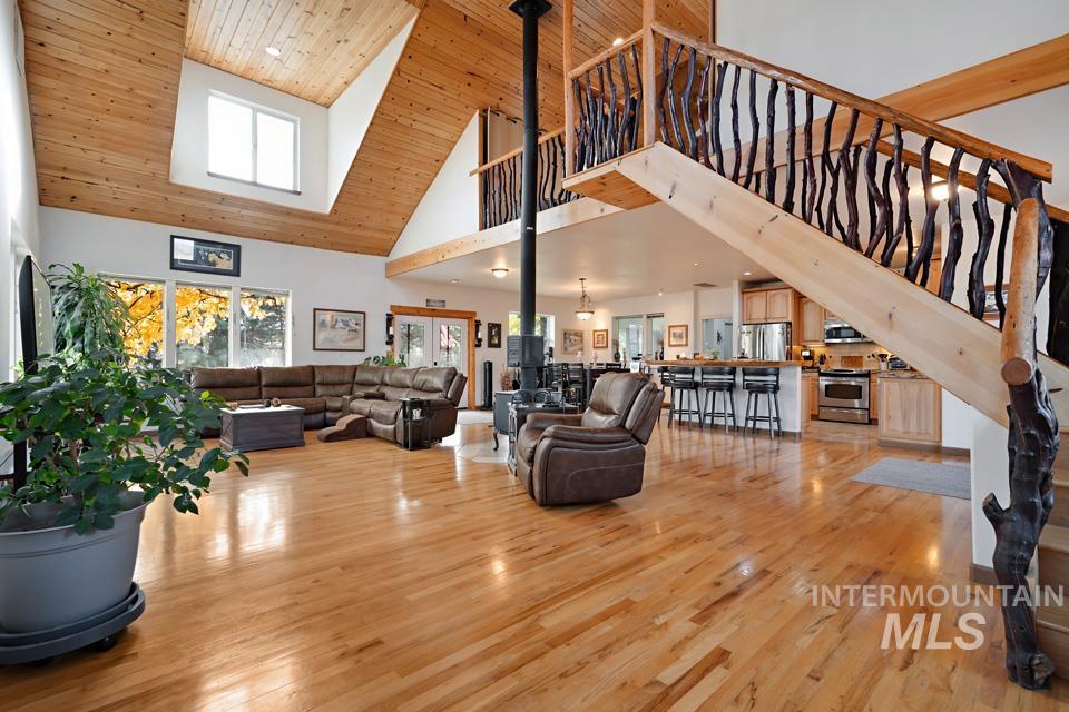 7025 Bluebird Lane Sweet, ID 83670 - Photo 8 of 46 Living area with wooden ceiling, light wood finished floors, high vaulted ceiling, and stairway