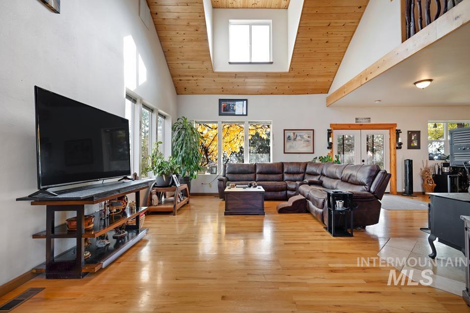 7025 Bluebird Lane Sweet, ID 83670 - Photo 9 of 46 Living area with high vaulted ceiling, wood ceiling, and light wood finished floors