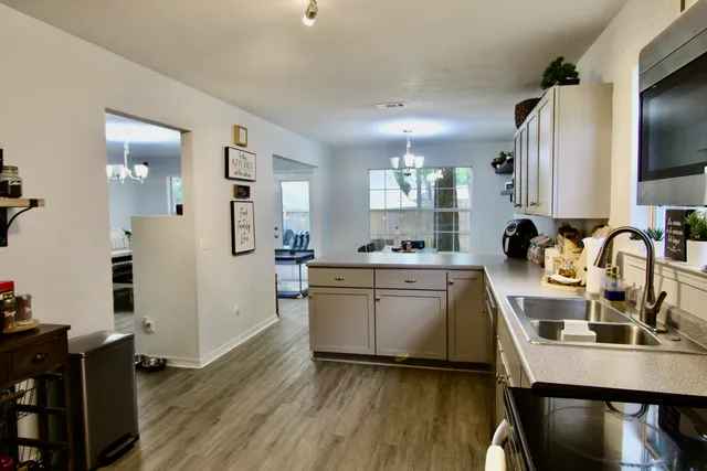 a kitchen with sink refrigerator and microwave