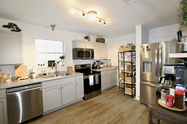 a kitchen with a sink appliances and cabinets