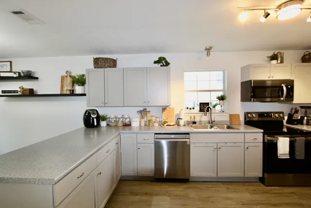 a kitchen with a sink a stove and cabinets