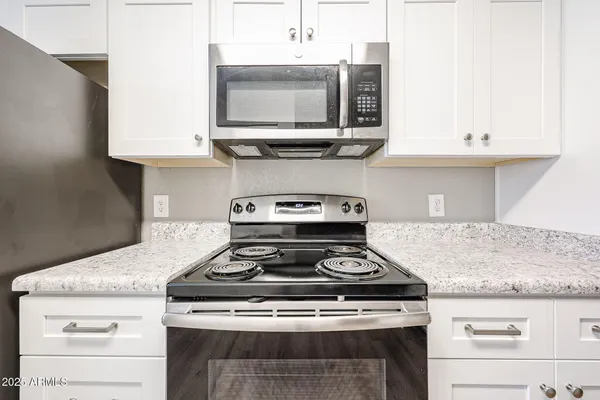 a stove top oven sitting inside of a kitchen