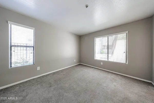a view of an empty room with windows