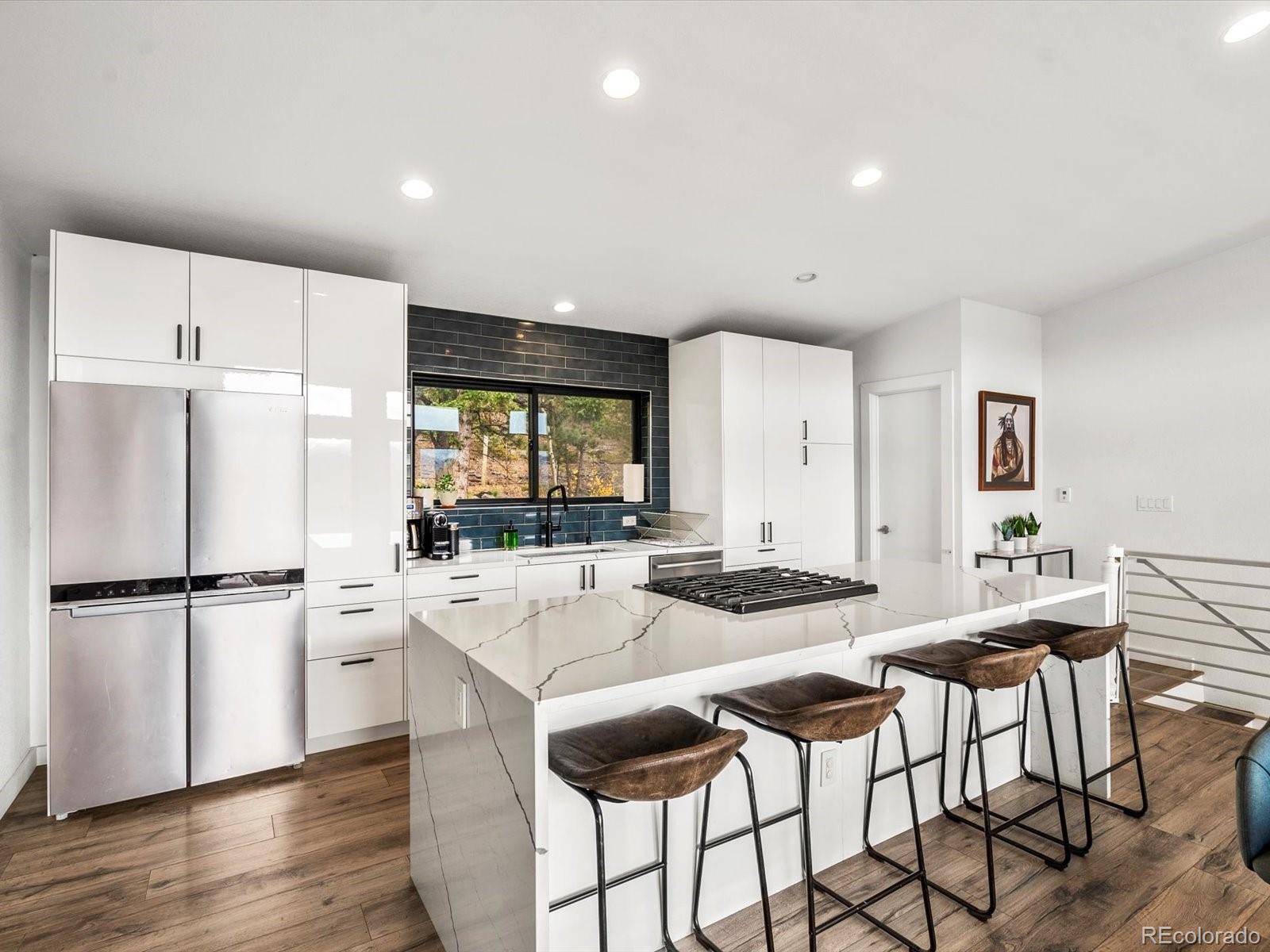 1044 Alps Hill Road Central City, CO 80427 - Photo 12 of 49 a kitchen with a refrigerator a stove a dining table and chairs
