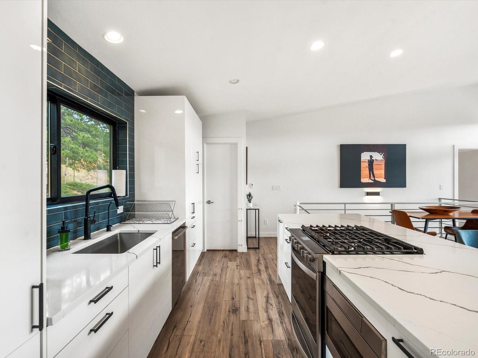 1044 Alps Hill Road Central City, CO 80427 - Photo 13 of 49 a kitchen with a stove a sink and a refrigerator