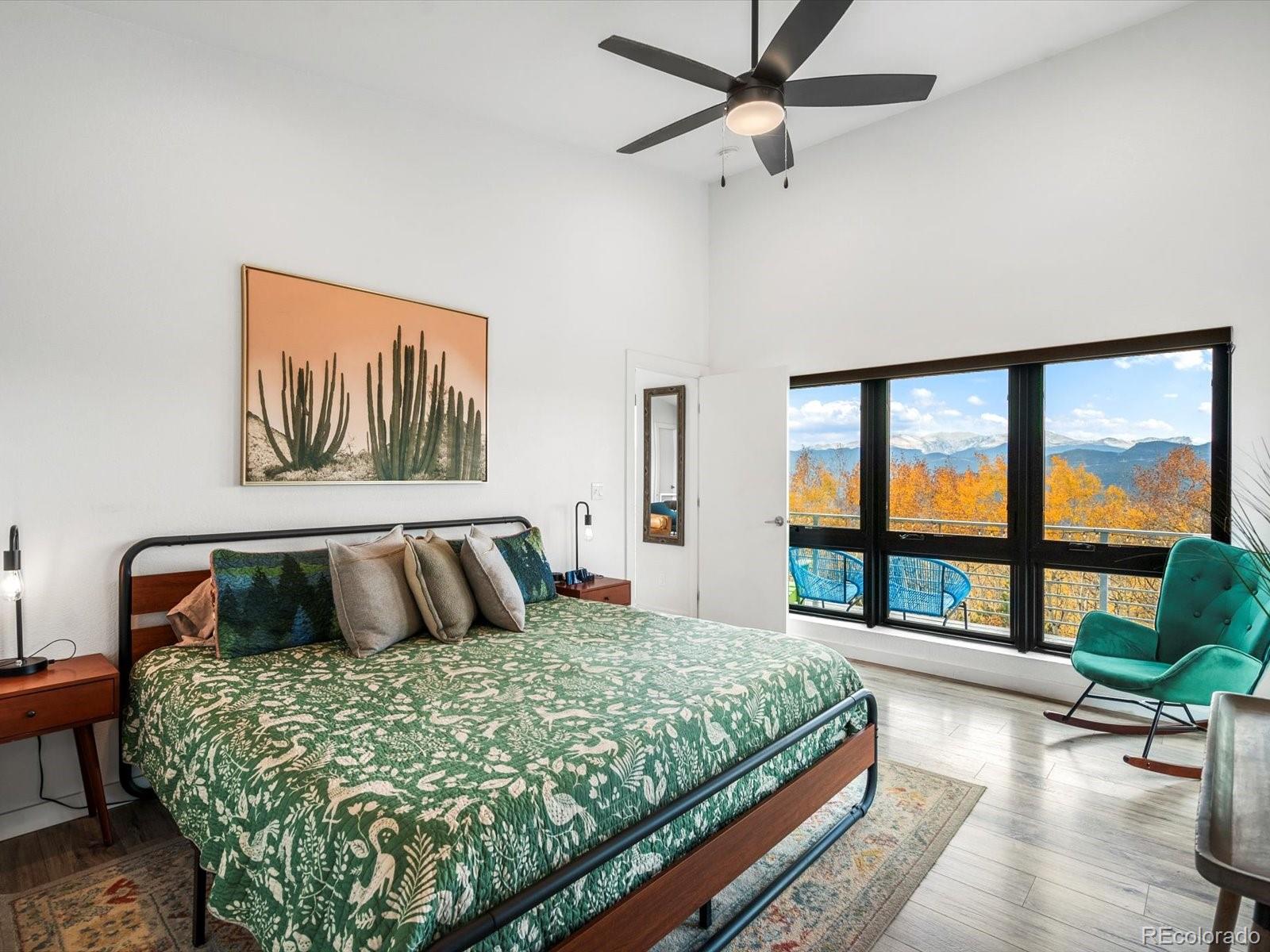 1044 Alps Hill Road Central City, CO 80427 - Photo 18 of 49 a bedroom with a large bed and a large window