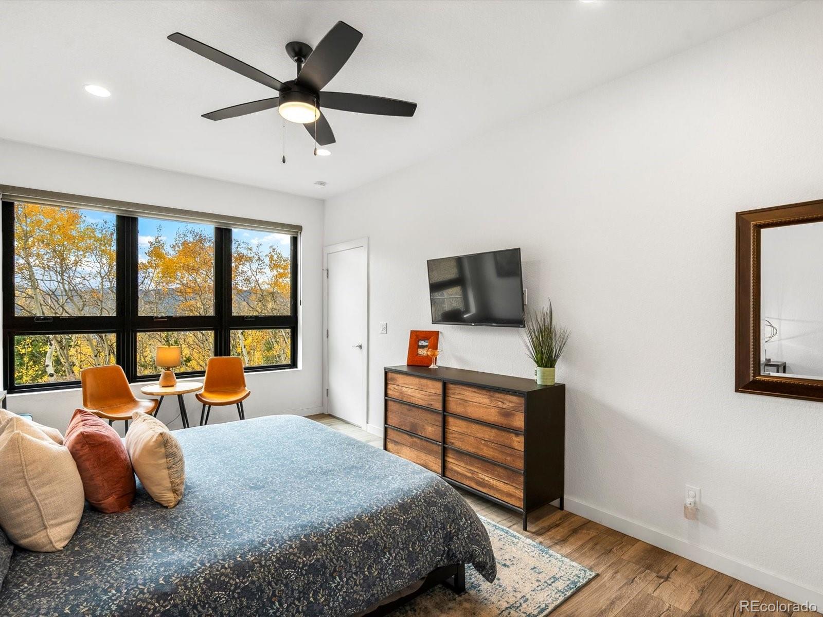 1044 Alps Hill Road Central City, CO 80427 - Photo 29 of 49 a bedroom with a bed and a flat screen tv