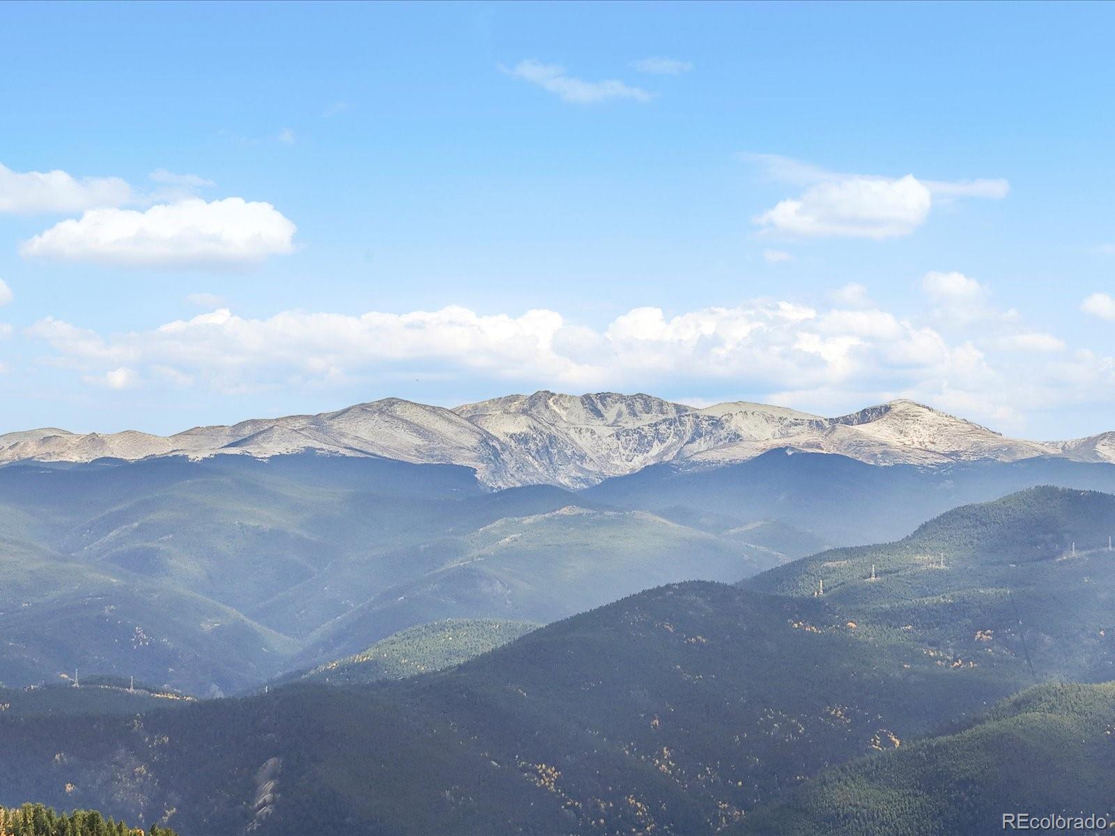 1044 Alps Hill Road Central City, CO 80427 - Photo 45 of 49 a view of a dry yard with mountains in the background