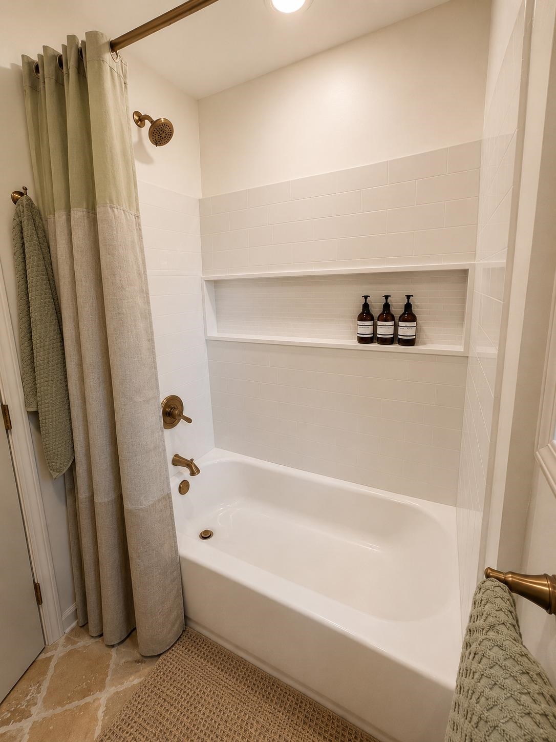 470 Rich Road Somerville, TN 38068 - Photo 39 of 40 Bathtub with subway tile surround, integrated shower niche, and bronze fixtures