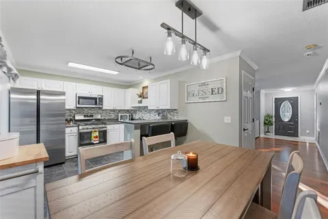 a kitchen with stainless steel appliances granite countertop a sink counter space and refrigerator