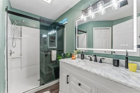 a bathroom with double vanity and a mirror