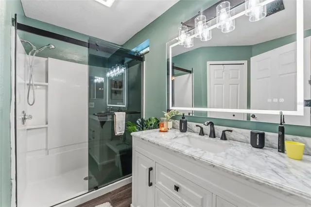 a bathroom with double vanity and a mirror