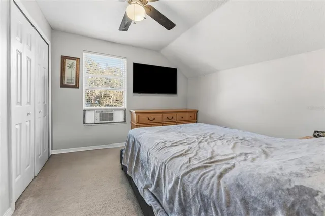 a bedroom with a large bed and a flat screen tv