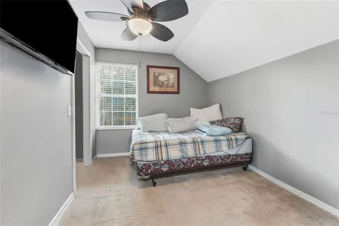 a bed sitting in a bedroom next to a window