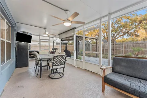 a dining room with furniture and a floor to ceiling window