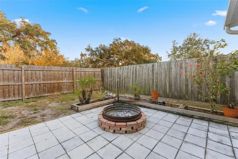 a backyard of a house with table and chairs