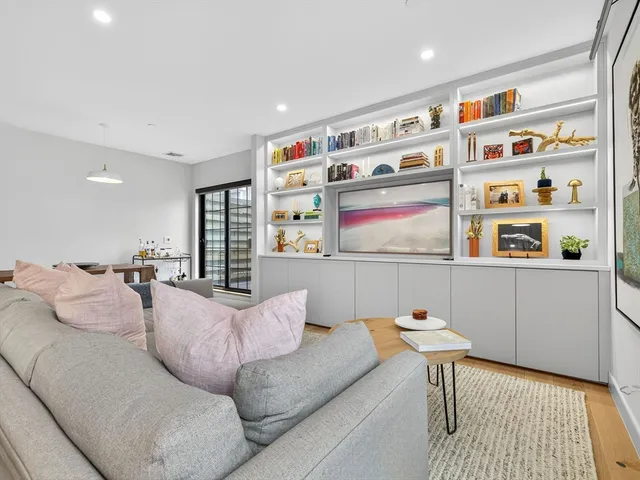 a living room with furniture cabinets and window
