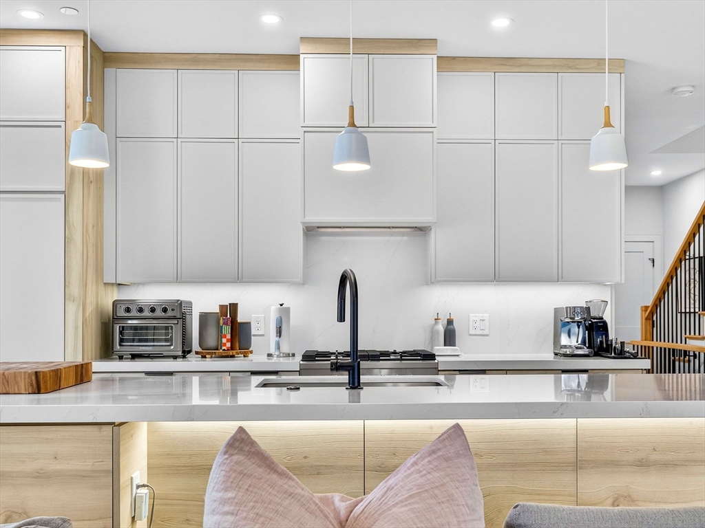 4 Payne Street, Unit FIVE Boston, MA 02122 - Photo 15 of 38 a kitchen with stainless steel appliances granite countertop a sink a stove and a granite counter tops