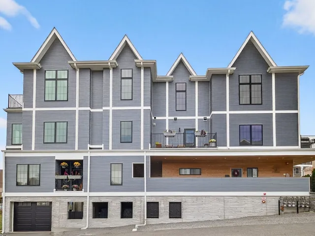 a front view of a residential apartment building with a yard