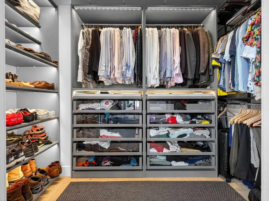 4 Payne Street, Unit FIVE Boston, MA 02122 - Photo 32 of 38 a view of walk in closet with clothes and shoes