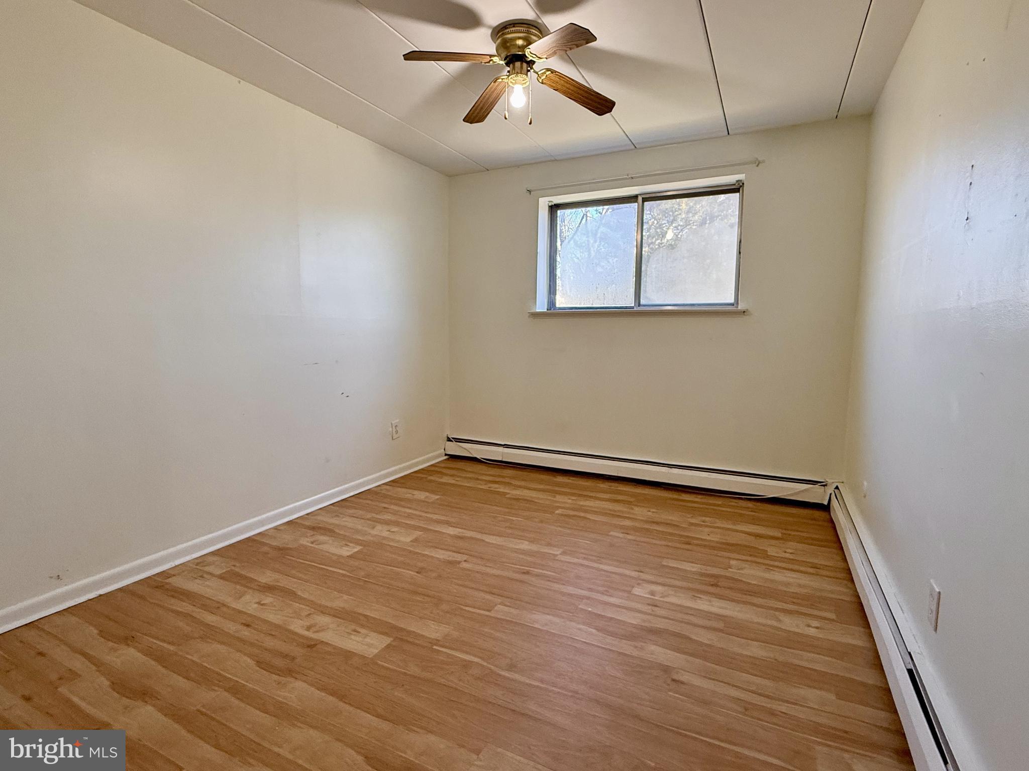 1575 West Street Road, Unit 327 Warminster, PA 18974 - Photo 8 of 17 wooden floor in an empty room with a window