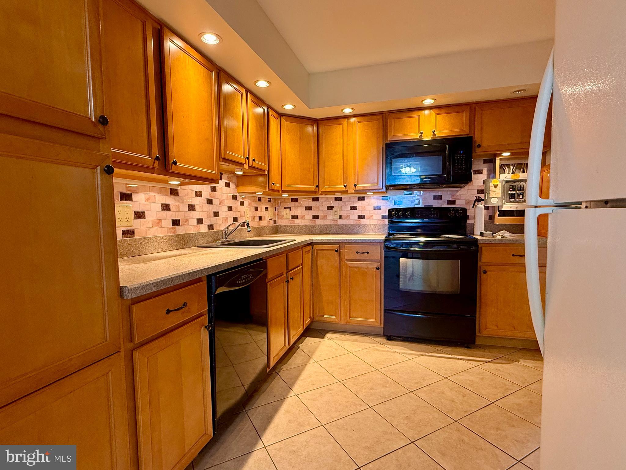 1575 West Street Road, Unit 327 Warminster, PA 18974 - Photo 10 of 17 a kitchen with stainless steel appliances granite countertop a stove a sink and a refrigerator