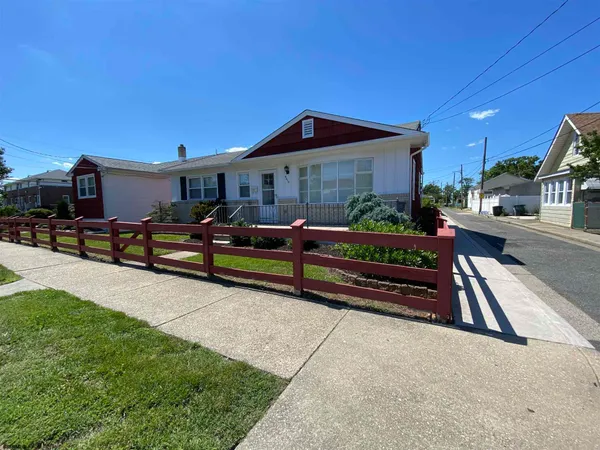 a wooden bench sitting in front of a house