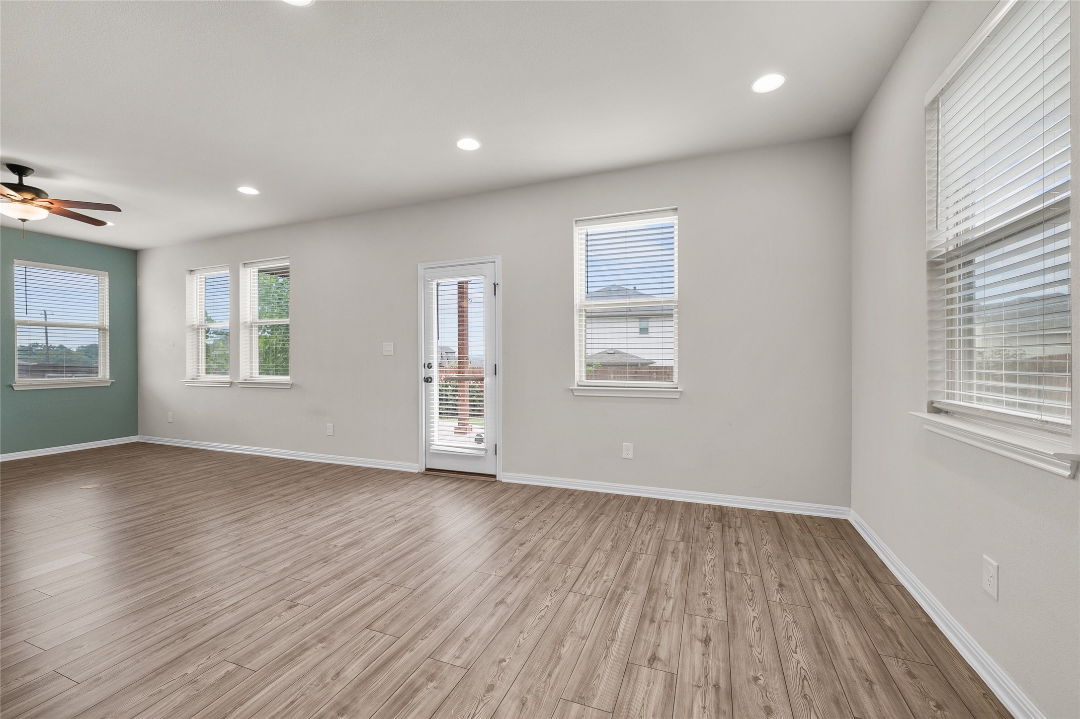 101 Lambert Street Leander, TX 78641 - Photo 15 of 33 Bright, spacious living area with resilient wood-look flooring and ample natural light.