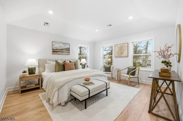 a bedroom with a bed a table and a window