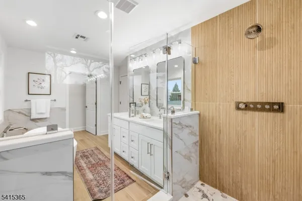 a bathroom with a bathtub and a shower