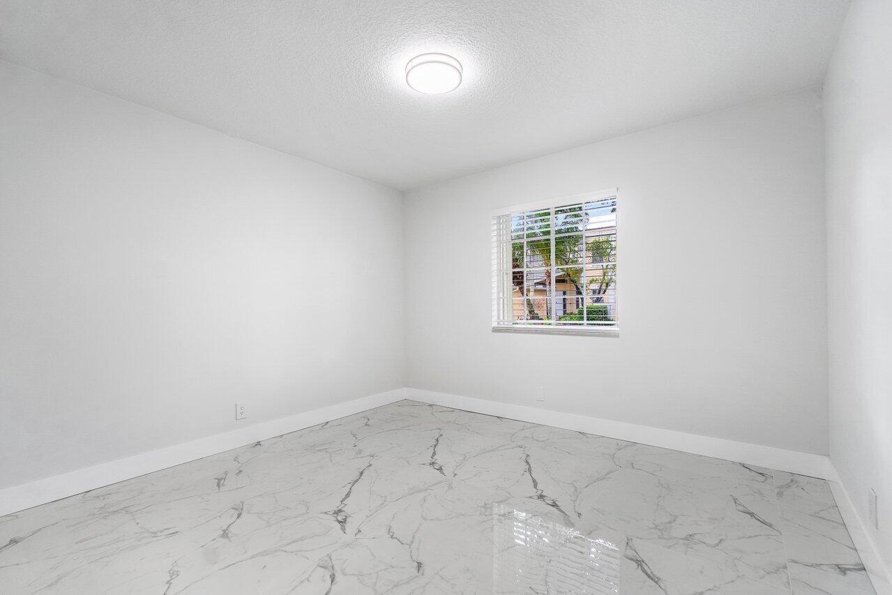 7809 Travelers Tree Drive Boca Raton, FL 33433 - Photo 13 of 33 an empty room with a window