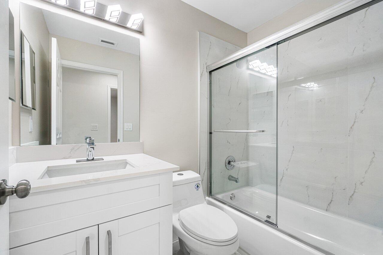 7809 Travelers Tree Drive Boca Raton, FL 33433 - Photo 15 of 33 a bathroom with a sink toilet and shower