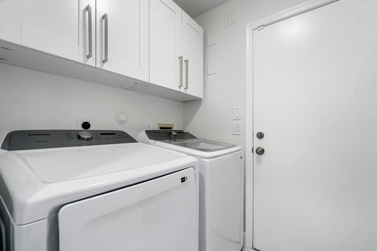 7809 Travelers Tree Drive Boca Raton, FL 33433 - Photo 16 of 33 a utility room with dryer and washer