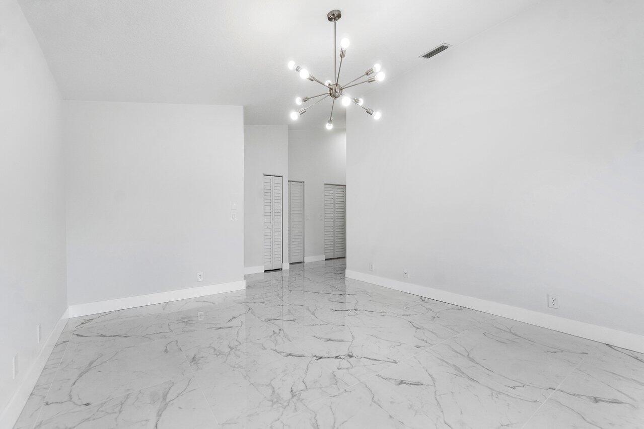 7809 Travelers Tree Drive Boca Raton, FL 33433 - Photo 17 of 33 a view of an empty room with a fan