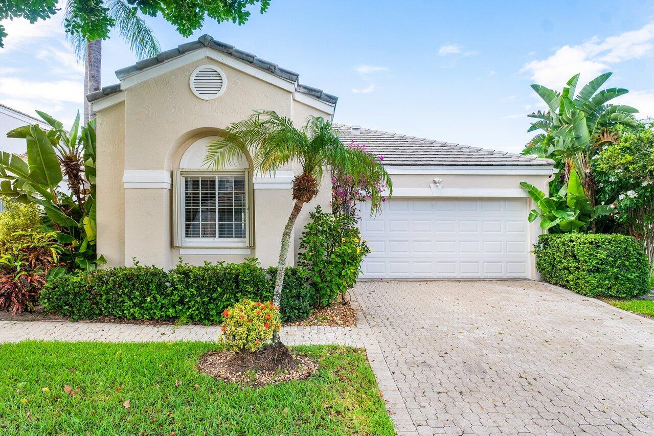 7809 Travelers Tree Drive Boca Raton, FL 33433 - Photo 2 of 33 a front view of a house with garden