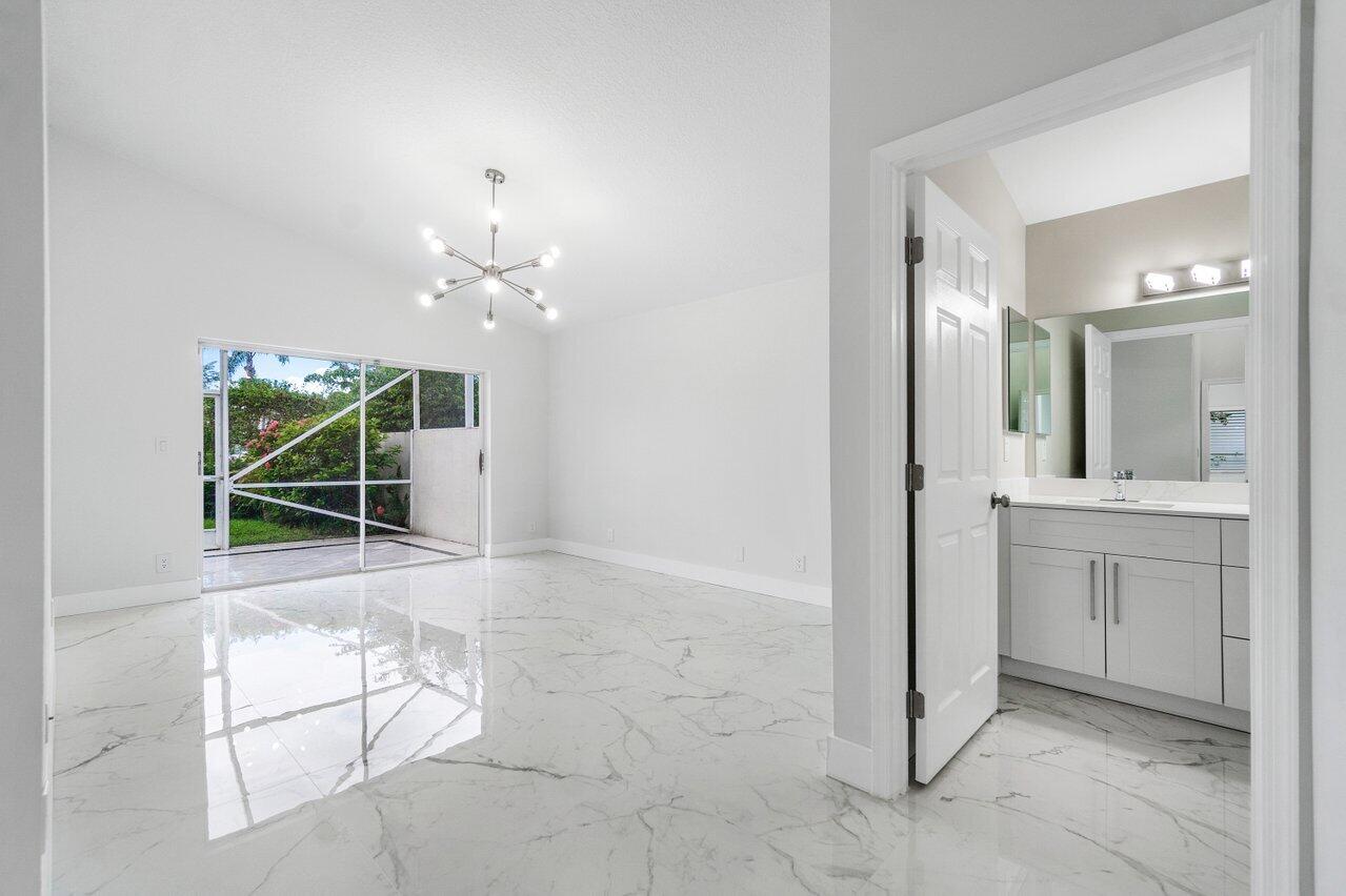 7809 Travelers Tree Drive Boca Raton, FL 33433 - Photo 22 of 33 a view of a bathroom with a sink and mirror