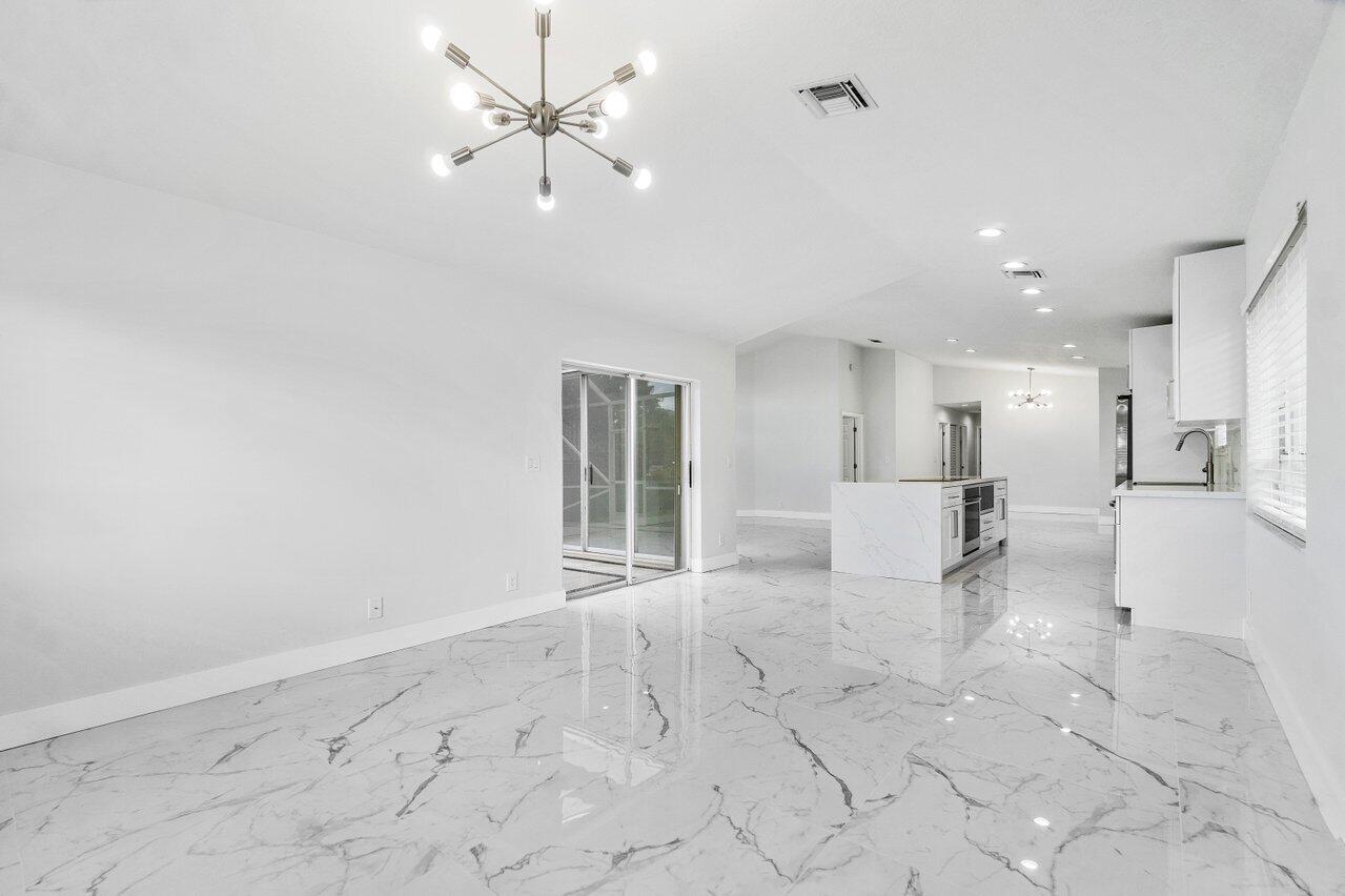 7809 Travelers Tree Drive Boca Raton, FL 33433 - Photo 23 of 33 a view of a livingroom with furniture a ceiling fan and window
