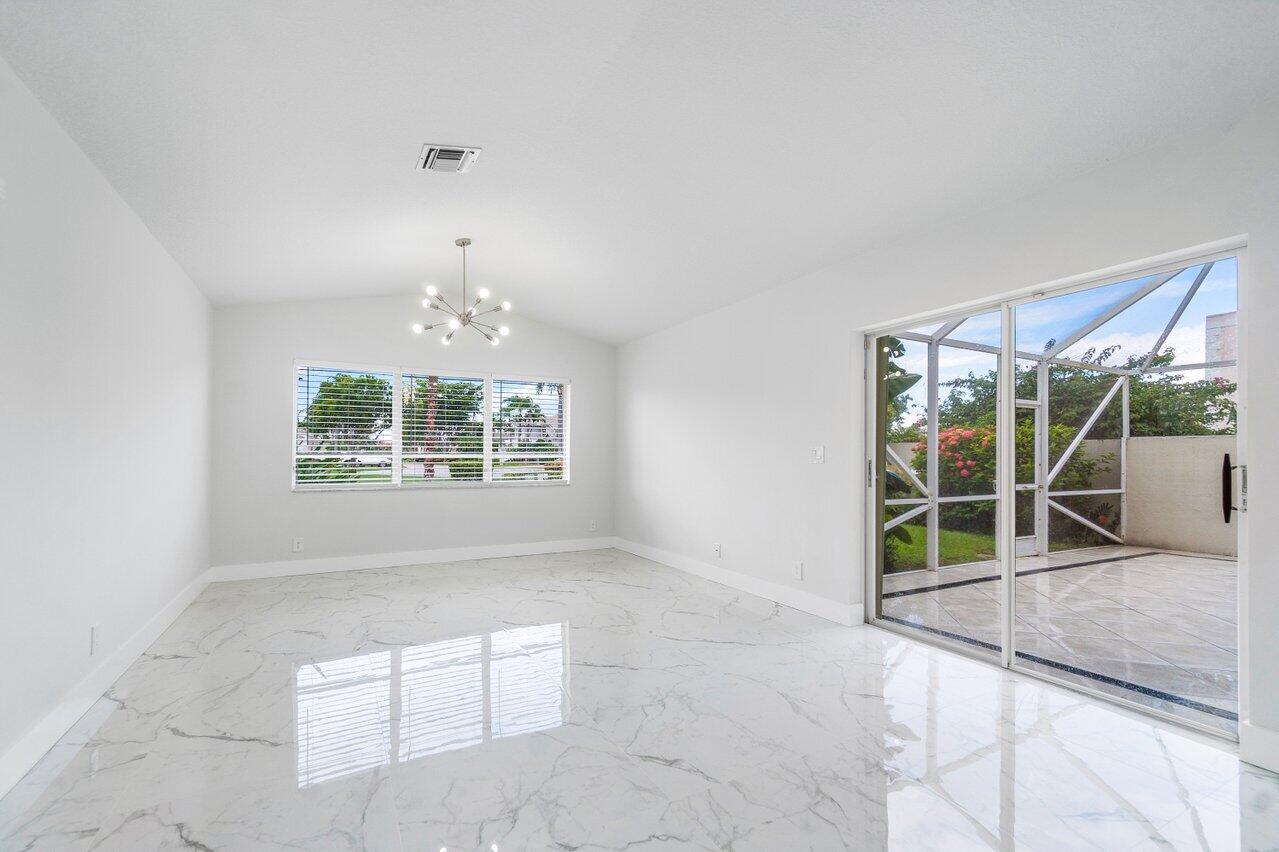 7809 Travelers Tree Drive Boca Raton, FL 33433 - Photo 25 of 33 en empty room with windows