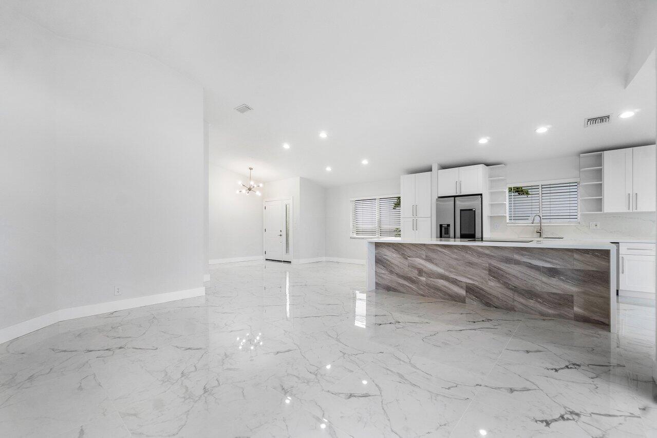 7809 Travelers Tree Drive Boca Raton, FL 33433 - Photo 28 of 33 a view of kitchen and empty room