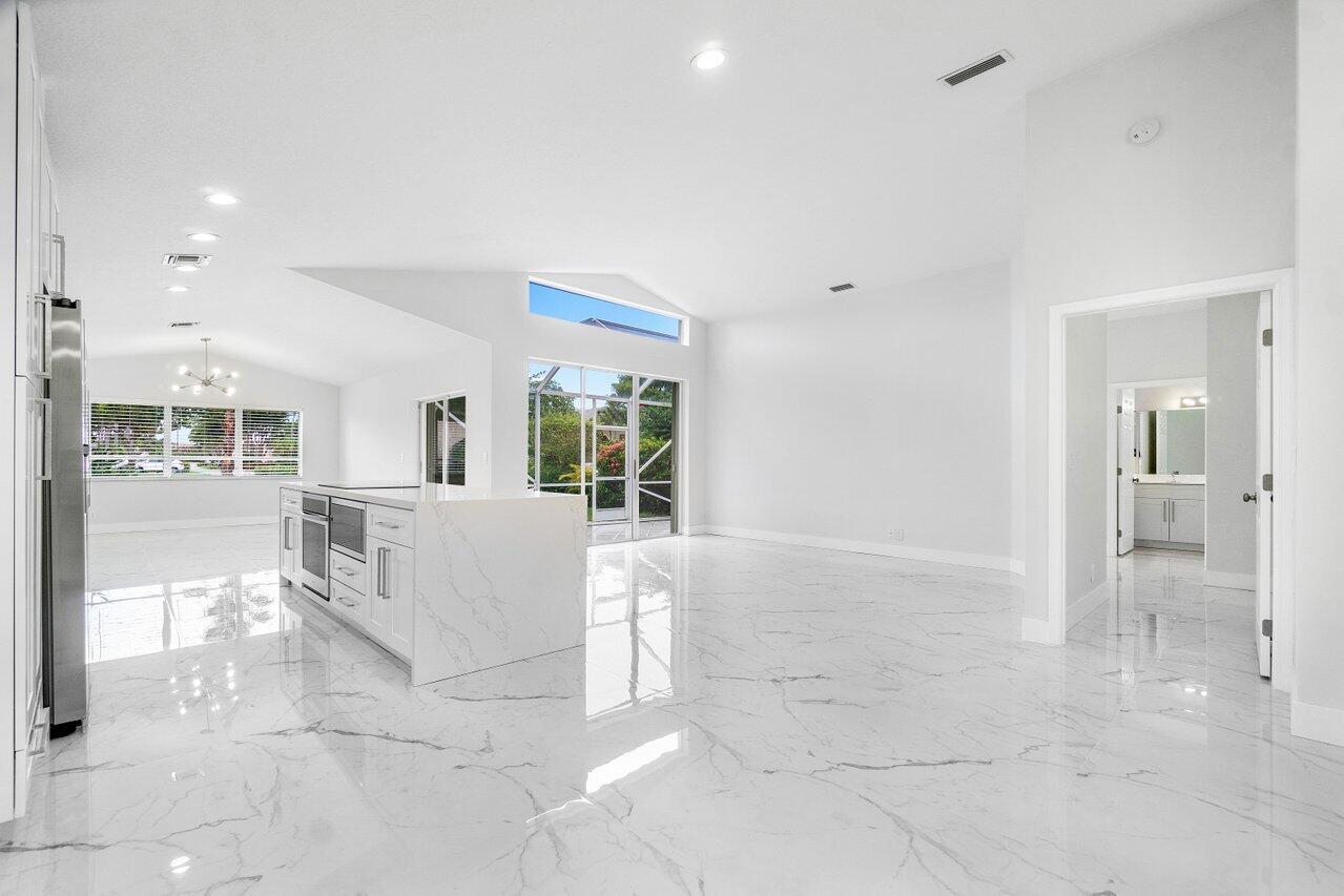 7809 Travelers Tree Drive Boca Raton, FL 33433 - Photo 31 of 33 a living room with couches and kitchen view