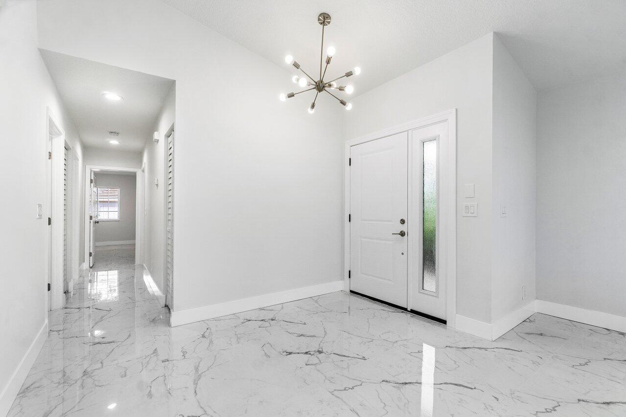7809 Travelers Tree Drive Boca Raton, FL 33433 - Photo 32 of 33 a view of a chandelier fan and entryway