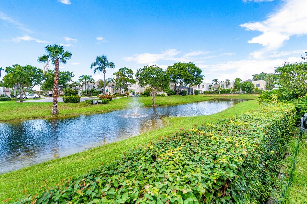 7809 Travelers Tree Drive Boca Raton, FL 33433 - Photo 6 of 33 a view of a lake with houses in the back