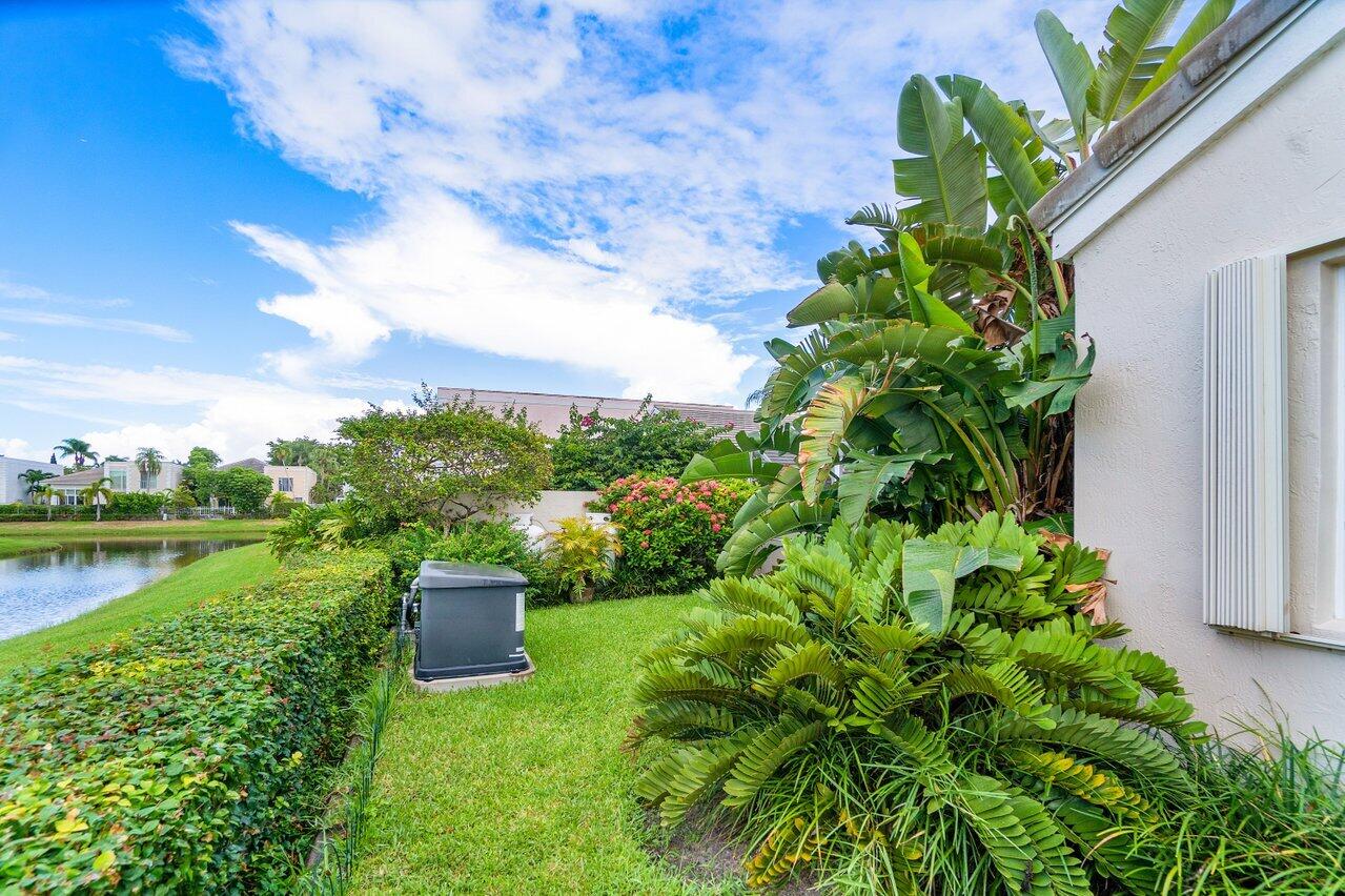 7809 Travelers Tree Drive Boca Raton, FL 33433 - Photo 7 of 33 a view of a garden with a lake