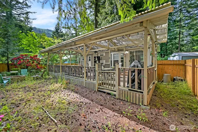 a view of a house with a small yard and wooden fence