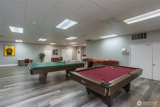 a room with pool table and window