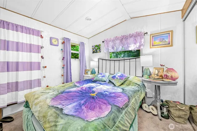 a bed sitting in a bedroom next to a window