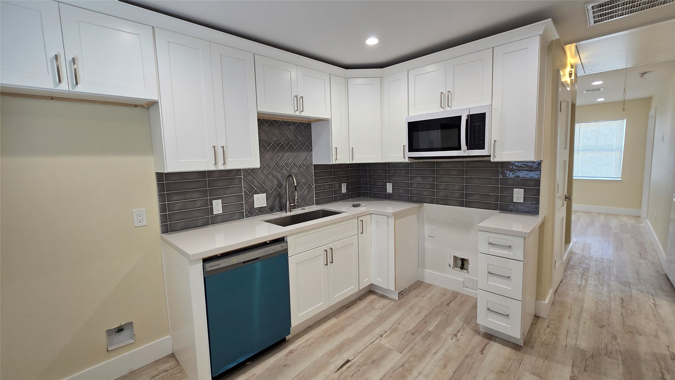 3741 Seabrook Street Houston, TX 77021 - Photo 9 of 50 a kitchen with stainless steel appliances granite countertop a sink and cabinets with wooden floor