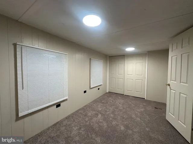 an empty room with closet area
