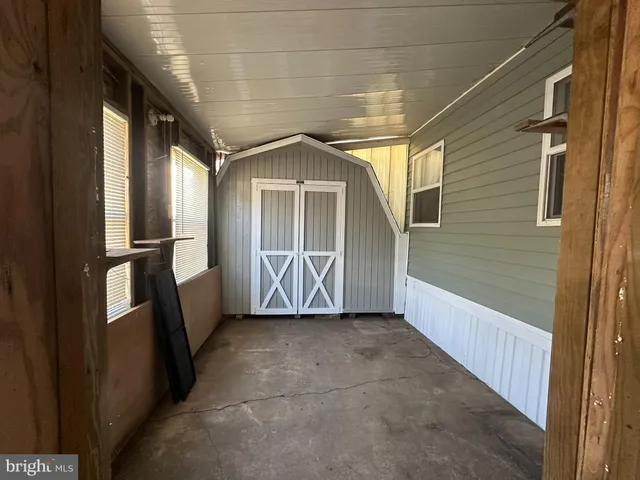 a view of an empty room with wooden shelves